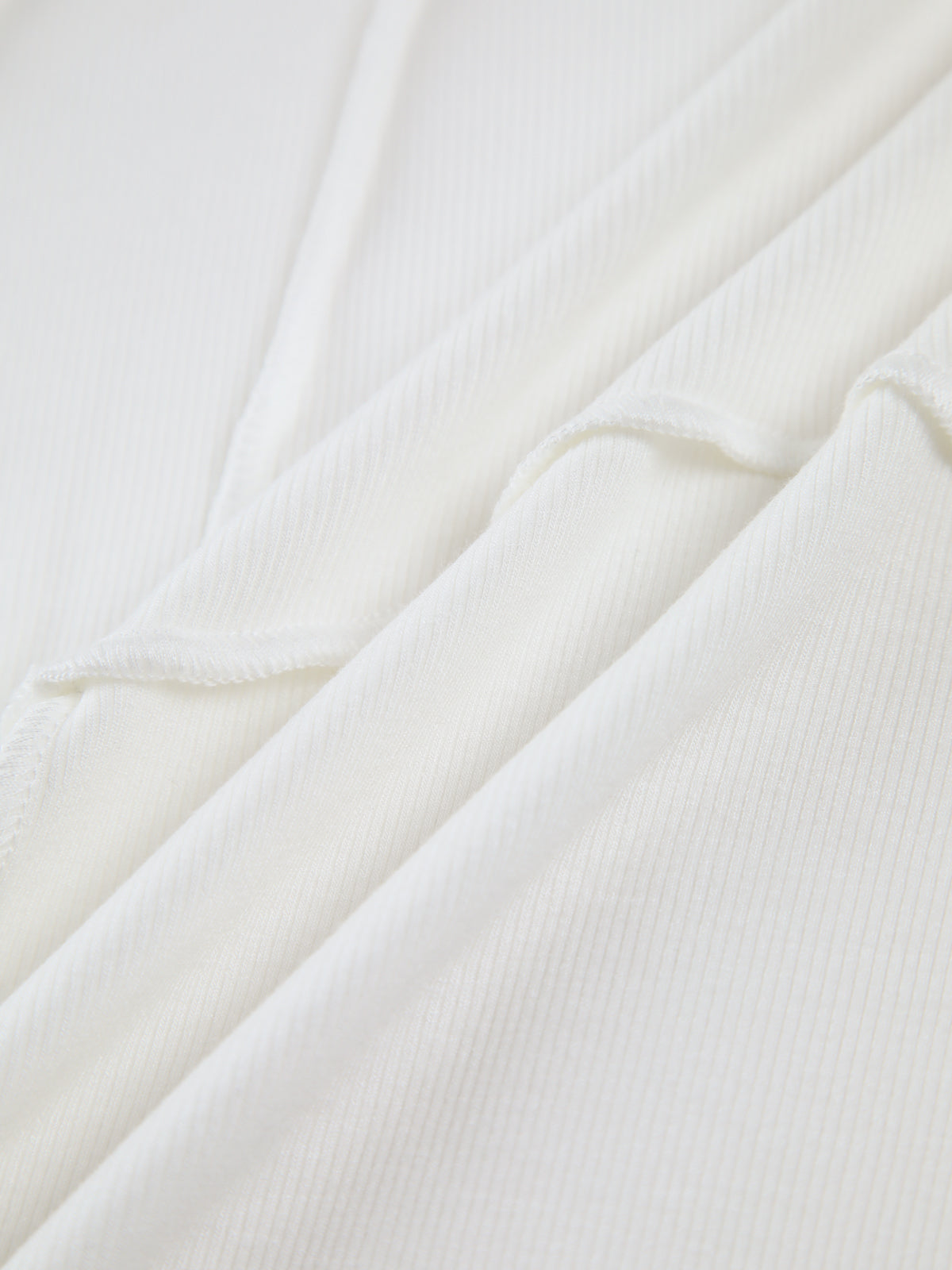 Top in Ribbed Knit — Long Sleeve Crew Neck with Exposed Seam Detail and Slim Fitted Silhouette